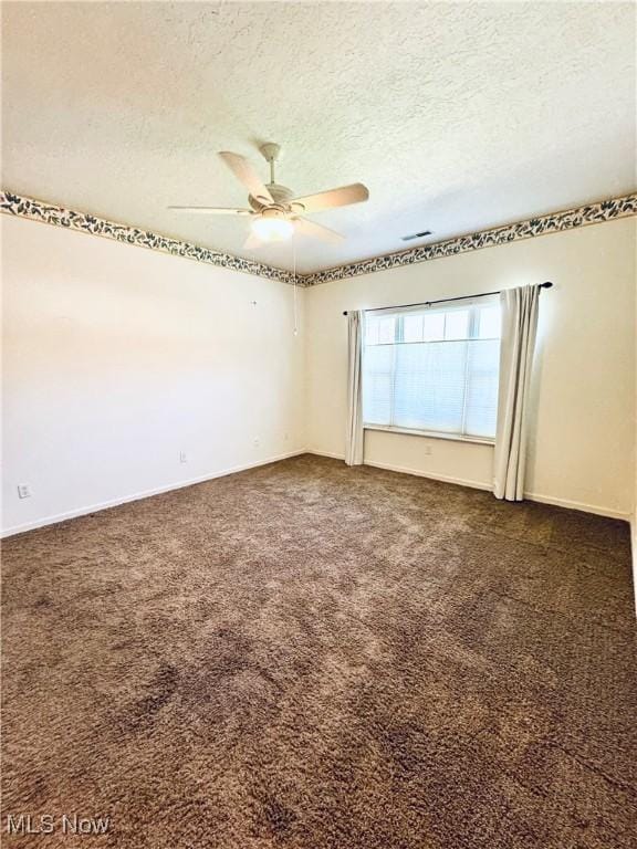 128 Wilcox Rd, Austintown, OH 44515 - carpeted spare room featuring baseboards, visible vents, a ceiling fan, and a textured ceiling