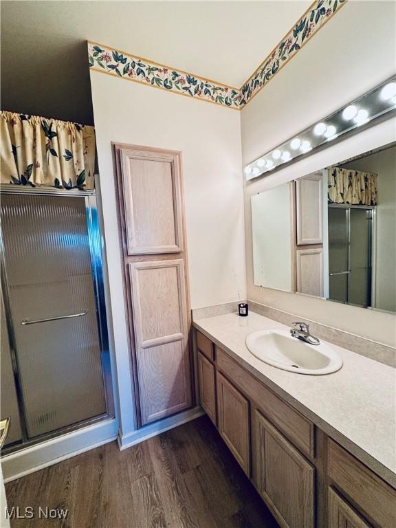 128 Wilcox Rd, Austintown, OH 44515 - bathroom featuring vanity, a shower with shower door, and wood finished floors