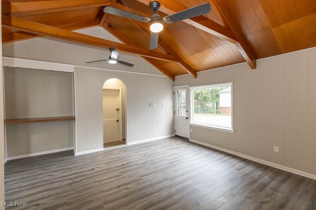 empty room with lofted ceiling with beams, dark hardwood / wood-style flooring, ceiling fan, and wood ceiling