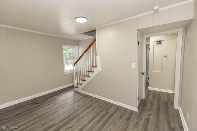 interior space with crown molding and dark hardwood / wood-style flooring