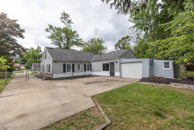 view of front of home with a garage and a front lawn