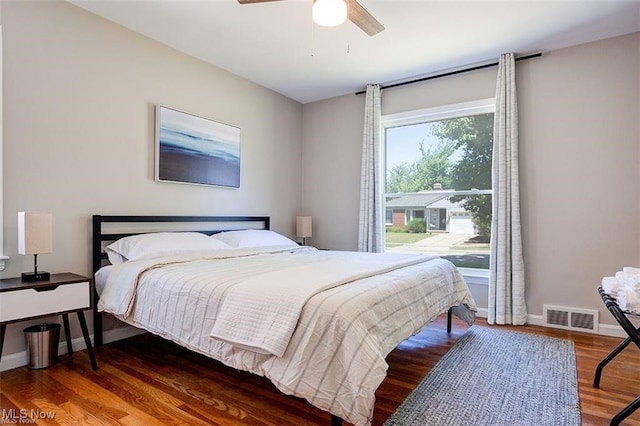 bedroom with ceiling fan and dark hardwood / wood-style floors