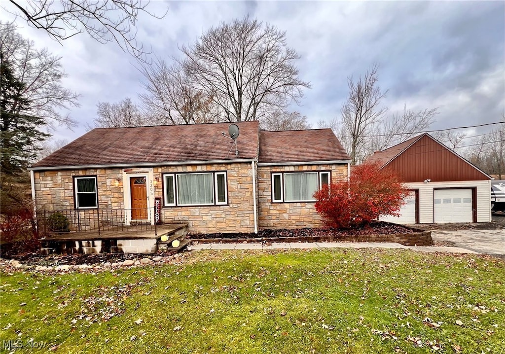 view of front of property with a garage and a front lawn