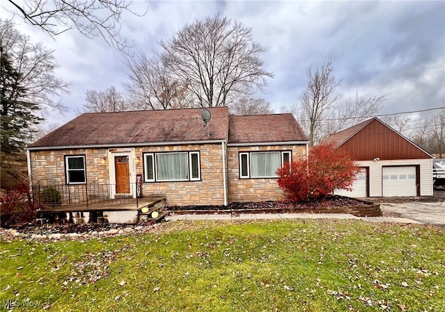 view of front of property with a garage and a front lawn