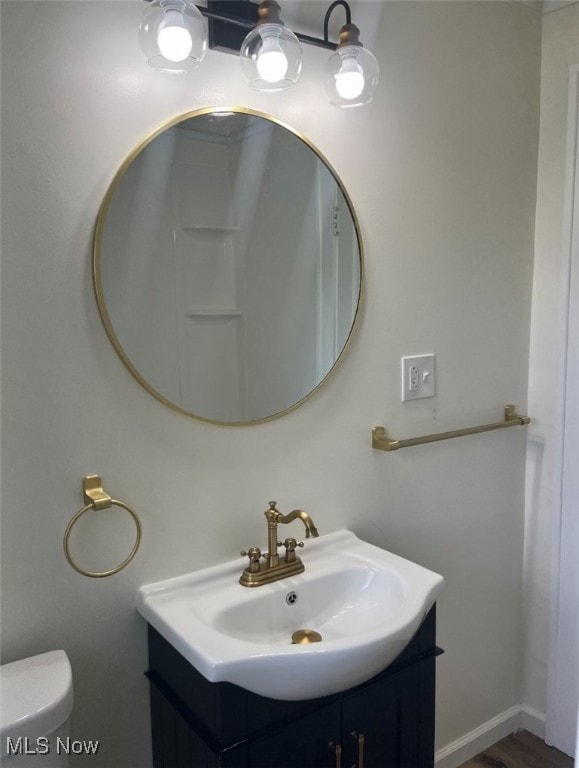 bathroom featuring toilet and vanity