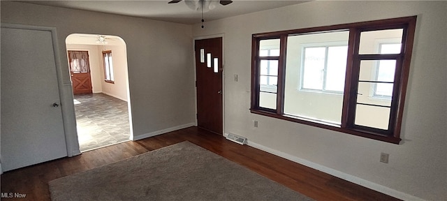 empty room featuring dark hardwood / wood-style flooring and ceiling fan