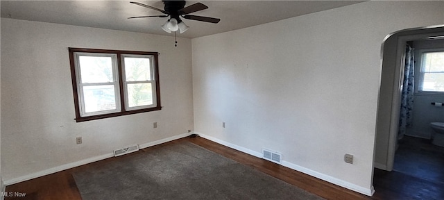 spare room featuring ceiling fan and dark hardwood / wood-style flooring