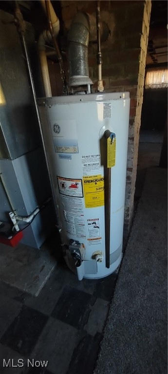 utility room featuring water heater