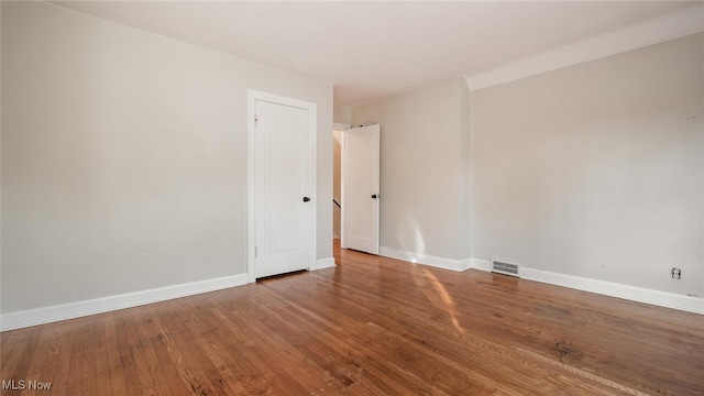 empty room with hardwood / wood-style floors