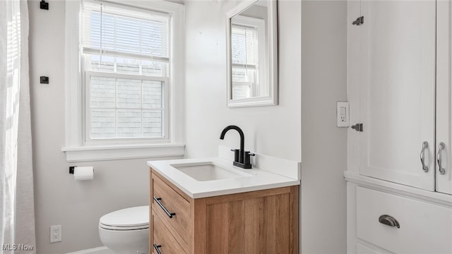 bathroom with toilet and vanity