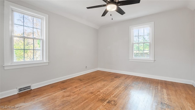 unfurnished room with ceiling fan, wood-type flooring, and plenty of natural light