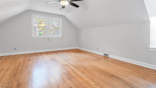 additional living space with ceiling fan, light hardwood / wood-style flooring, and vaulted ceiling