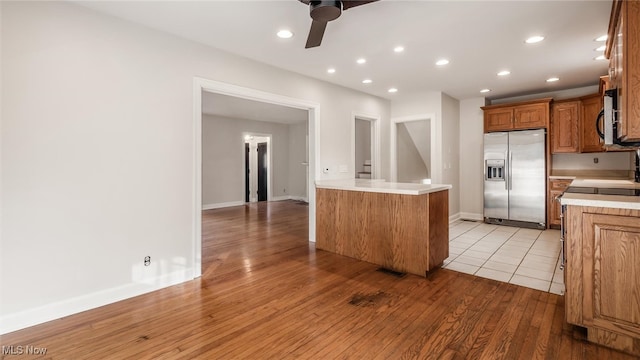 kitchen with ceiling fan, light hardwood / wood-style flooring, and appliances with stainless steel finishes