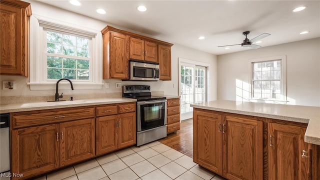 kitchen featuring light wood-type flooring, appliances with stainless steel finishes, sink, and plenty of natural light