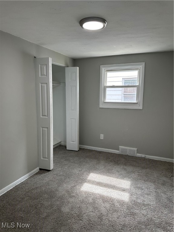 unfurnished bedroom featuring a closet and carpet