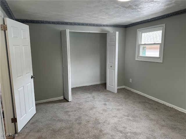 unfurnished bedroom with carpet floors and a textured ceiling