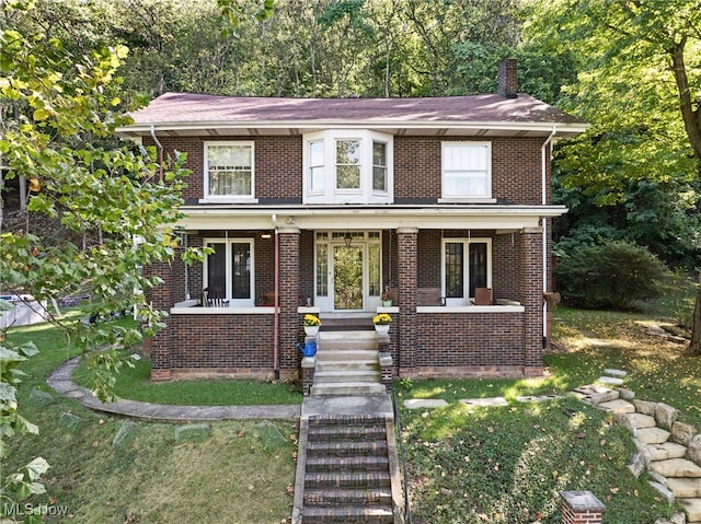 view of front of home featuring a front lawn and a porch