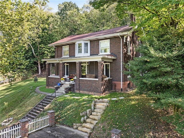 view of front of house with a front lawn and a porch