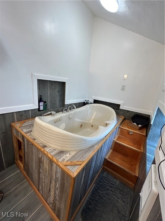 miscellaneous room featuring dark hardwood / wood-style flooring and lofted ceiling