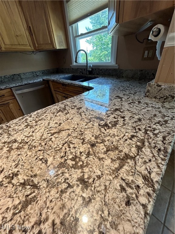 kitchen featuring sink and stone countertops