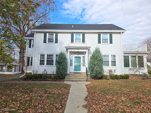 colonial-style house with a balcony