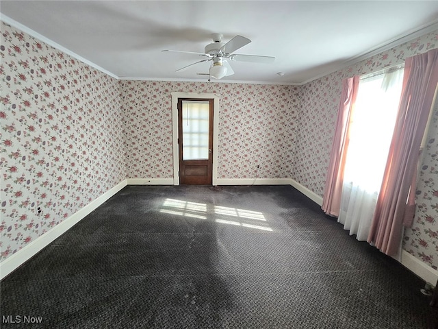 carpeted spare room featuring ceiling fan and crown molding