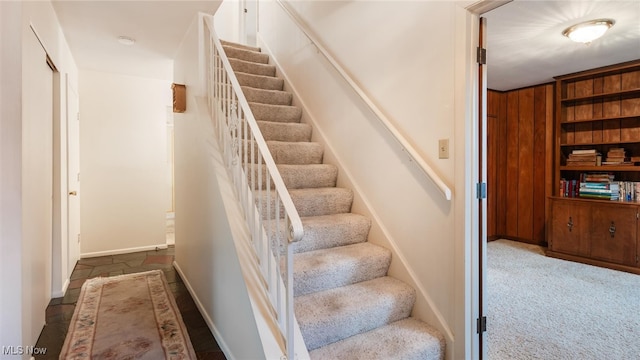 staircase featuring carpet flooring