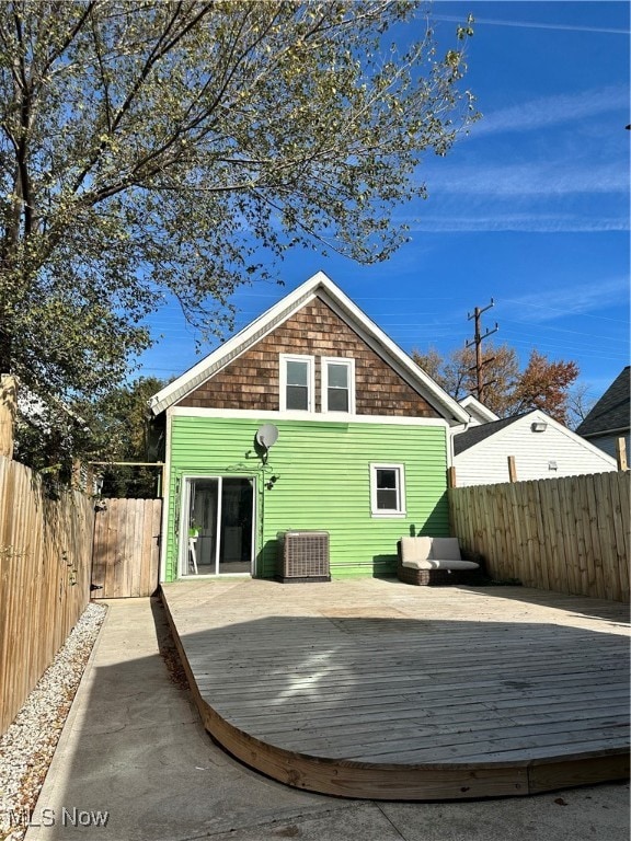 back of house featuring a wooden deck