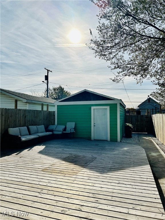 deck with an outdoor hangout area and a storage shed