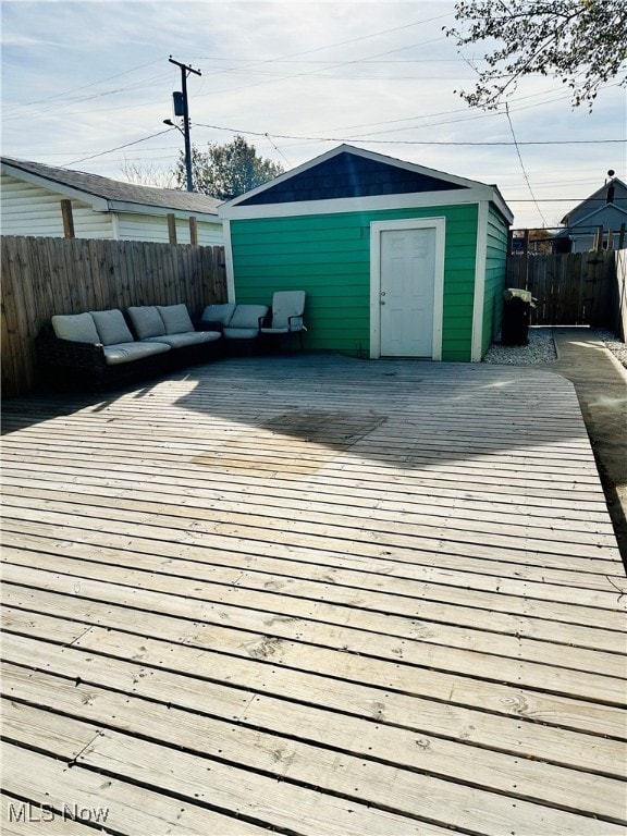 wooden deck featuring outdoor lounge area and a storage shed