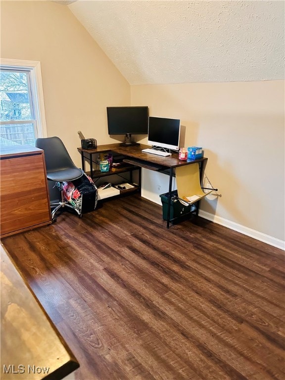 home office featuring a textured ceiling, dark hardwood / wood-style flooring, and vaulted ceiling