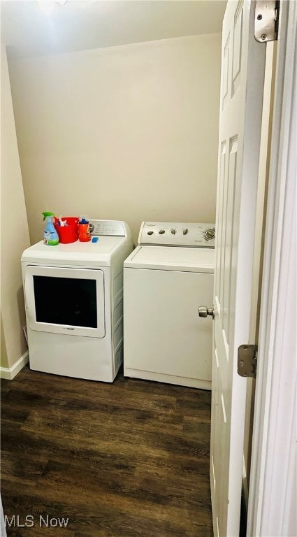 washroom featuring dark hardwood / wood-style flooring and washing machine and dryer