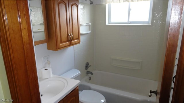 full bathroom with vanity, tiled shower / bath, and toilet