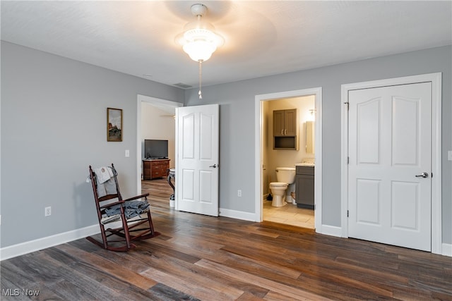 sitting room with dark wood-type flooring