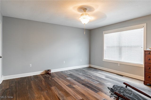 empty room with hardwood / wood-style flooring and ceiling fan