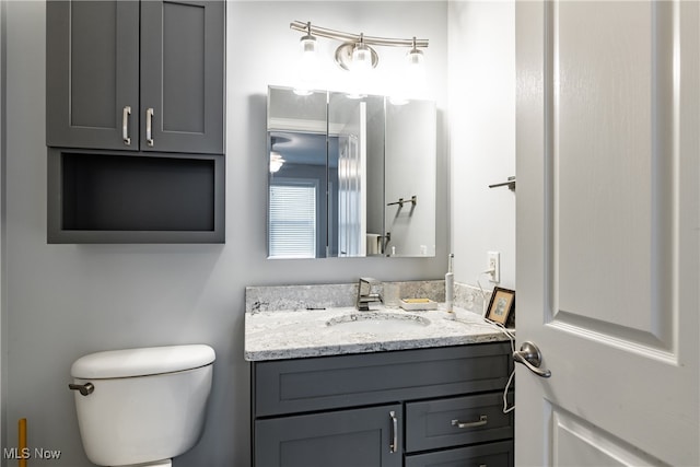 bathroom featuring vanity and toilet