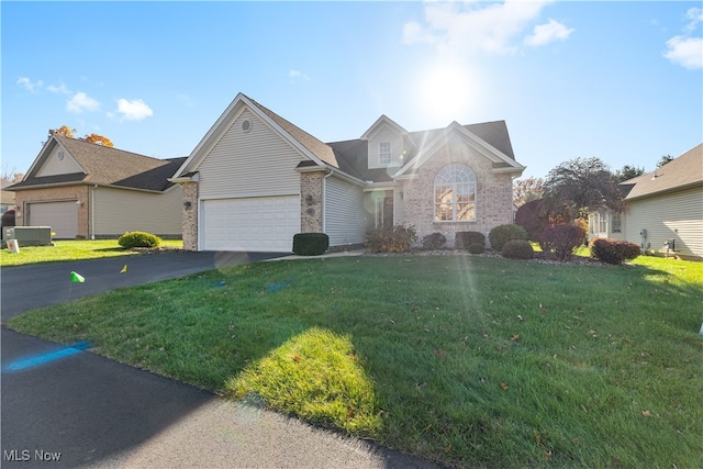 view of property featuring a garage and a front yard