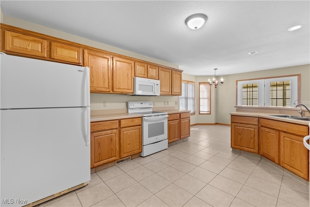 kitchen featuring sink, hanging light fixtures, a notable chandelier, white appliances, and light tile patterned floors