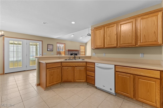 kitchen with kitchen peninsula, ceiling fan with notable chandelier, sink, dishwasher, and light tile patterned flooring