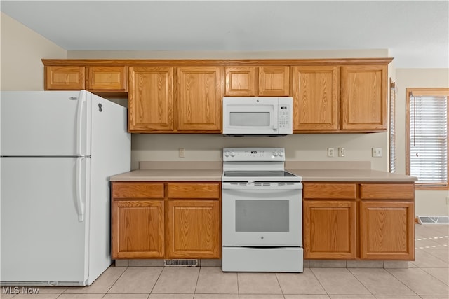 kitchen with light tile patterned floors and white appliances