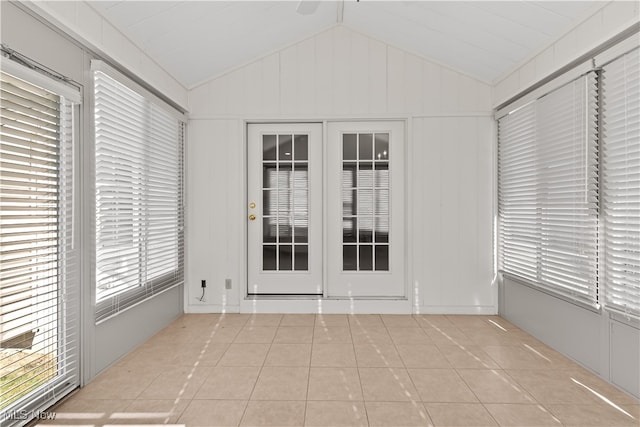 tiled empty room with lofted ceiling