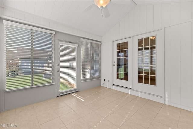 unfurnished sunroom with ceiling fan and lofted ceiling