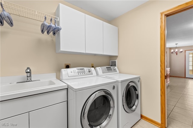 washroom with cabinets, sink, separate washer and dryer, a notable chandelier, and light tile patterned flooring