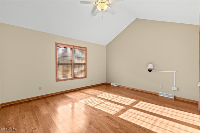 unfurnished room featuring hardwood / wood-style flooring, ceiling fan, and vaulted ceiling