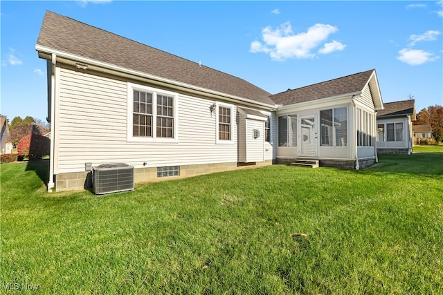 back of house with a lawn and cooling unit