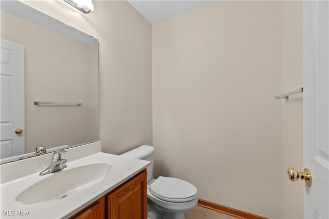 bathroom featuring tile patterned floors, vanity, and toilet