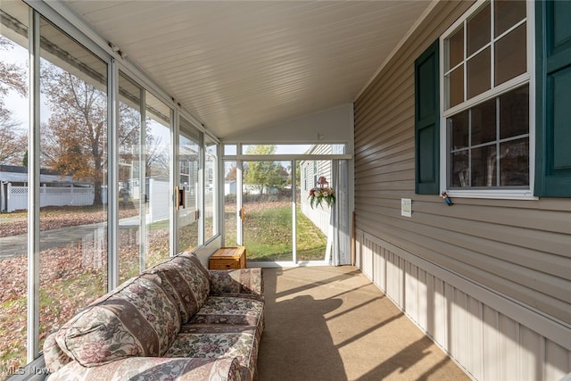 sunroom featuring lofted ceiling