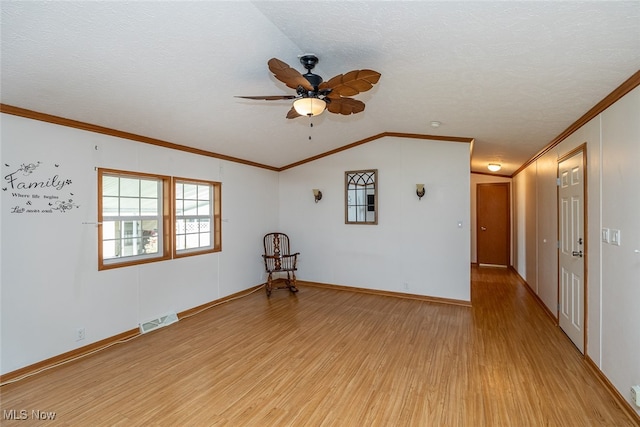 unfurnished room with crown molding, light hardwood / wood-style flooring, lofted ceiling, and a textured ceiling