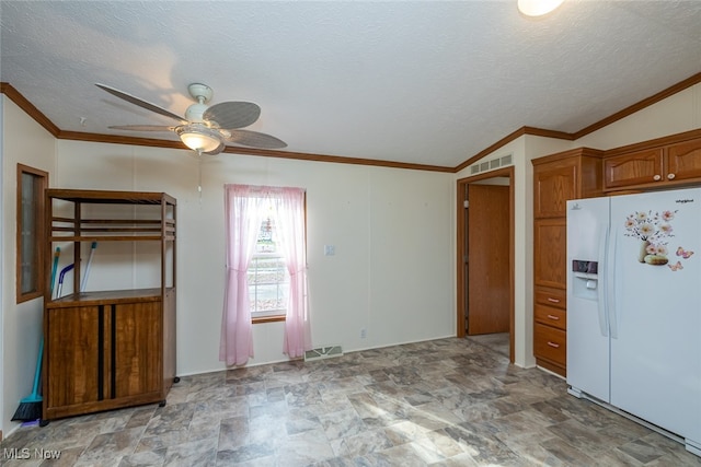 kitchen featuring a textured ceiling, lofted ceiling, ceiling fan, and white refrigerator with ice dispenser