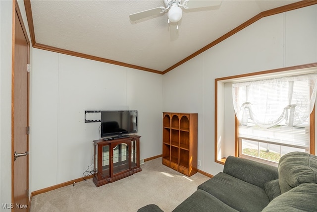 carpeted living room with lofted ceiling, a textured ceiling, ceiling fan, and crown molding